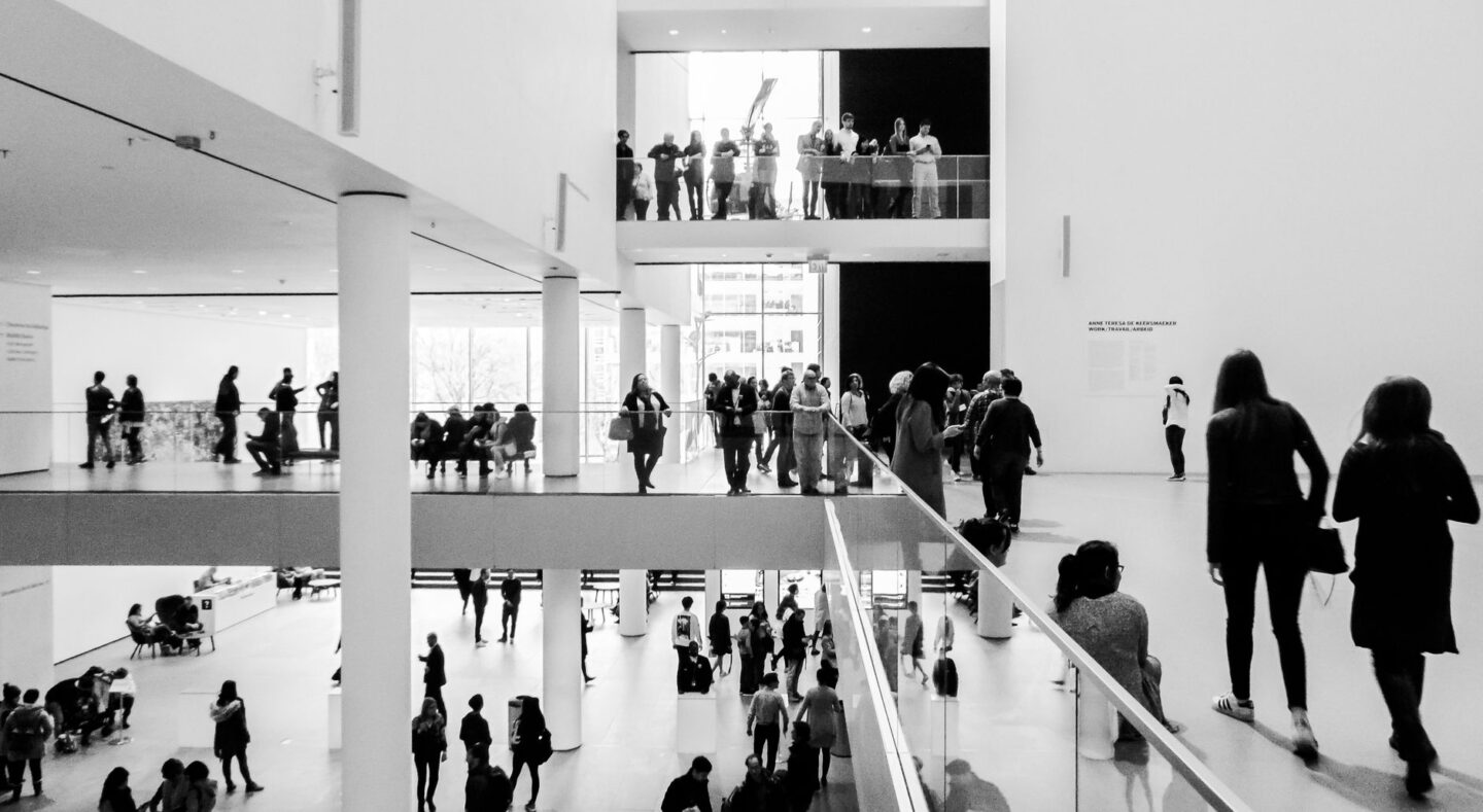 black and white museum interior with visitors